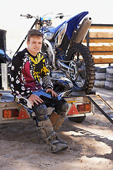 Image showing Sport, portrait and man with motorcycle for outdoor training, adventure and challenge on trailer. Extreme, adrenaline and young male person or motorbike for competition, gear and excitement.