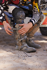 Image showing Hands, boots and motorbike with person getting ready for competition, race or training closeup. Exercise, fitness and sports with athlete outdoor in preparation of off road action or performance