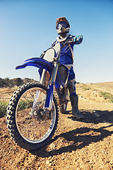 Image showing Motorcycle, sports and danger with biker person outdoor, low angle with uniform for riding on dirt track. Speed, power and risk with motorbike, transportation and adventure for adrenaline and travel