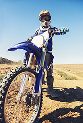 Image showing Motorbike, sports and danger with biker person outdoor, low angle with uniform for riding on dirt track. Speed, power and risk with motorcycle, transportation and adventure for adrenaline and travel