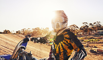 Image showing Sports, dirtbike and man in helmet, training and off road riding with desert glare. Extreme transport, bike and gear for motorbike competition, freedom and adrenaline for professional racing male