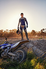 Image showing Portrait, motocross and rider by dirtbike in forest, confident and extreme sport for adventure with speed. Man, pride or gear for motorcycle racing on track, sunset or skill in driving a fast vehicle