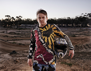 Image showing Man, portrait and dessert of professional motorcyclist or dirt bike racer with helmet in confidence for extreme sports. Confident male person, expert or rally rider in dunes for outdoor competition