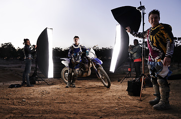 Image showing Photoshoot, motorcycle and person in nature with lighting, equipment and tools for creative project. Gear, group of people and helmet for extreme sport production and photography on off road track.