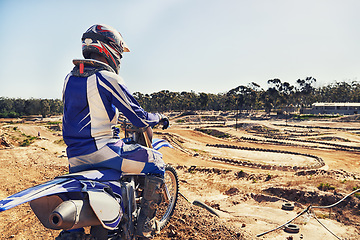 Image showing Person, motorcyclist or expert on dirt track for extreme sports, outdoor competition or race. Rear view of professional rider on motorbike or scrambler for sand course, challenge or off road rally