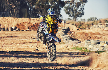 Image showing Motorcycle, action and balance, person on race track for adrenaline and stunt with extreme sports outdoor. Competition, adventure and power with risk, biker riding on motorbike with speed and skill