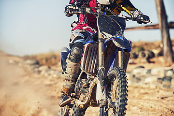 Image showing Person, motorcyclist and track with dirt bike for race, extreme sports or outdoor competition. Closeup or legs of expert rider on motorbike, scrambler or sand course for off road rally challenge