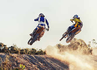 Image showing Sport, racer and dirtbike in action for competition on dirt road with performance, challenge and adventure. Motocross, motorbike or motorcycle driver with helmet on offroad course and path for racing