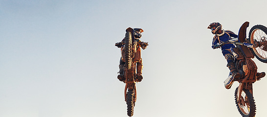 Image showing Sky, jump and men on motorcycle together for stunt at competition, training or challenge with banner mockup. Adventure, professional or athlete in air on motorbike for hobby, extreme sports or trick.