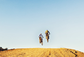 Image showing Rear view, racer and motorcycle in action for competition on dirt road with performance, challenge and adventure. Motocross, motorbike or dirtbike driver with jump stunt on offroad course for racing