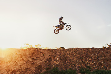 Image showing Person, jump and motorcyclist in the air on mockup with sunset for trick, stunt or ramp on outdoor dirt track. Expert rider on motorbike with lift off for extreme sports or rally challenge in nature