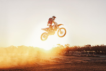 Image showing Person, jump and motorcyclist with sunset for trick, stunt or ramp on mockup or outdoor dirt track. Expert rider on motorbike in the air with lift off for extreme sports or rally challenge in nature