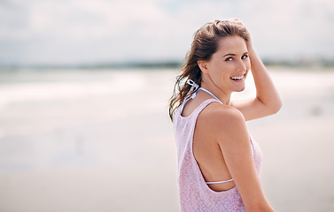 Image showing Happy woman, portrait and beach for summer vacation, holiday or tropical weekend in nature. Face of young female person with smile for fun travel, walk or enjoying outdoor day by the ocean coast