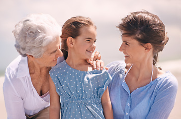 Image showing Smile, wind and family on beach in summer together for outdoor travel, holiday or vacation. Face of grandma, mother and daughter in nature for generation bonding at coast or tropical weekend getaway