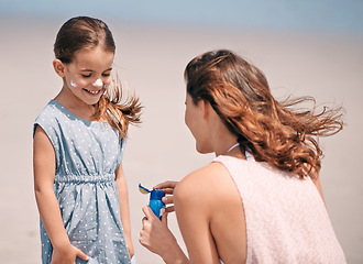 Image showing Happy mother, child and sunscreen bottle at beach for summer holiday, vacation or travel. Girl, kid or mom apply sunblock cream outdoor for protection, health or skincare of family together in nature