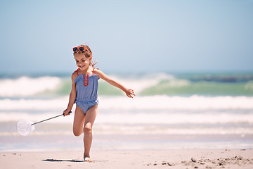 Image showing Happy, little girl and playing with net at the beach for fun holiday, weekend or outdoor summer on mockup. Excited person, child or young kid with smile for day of catch by the ocean coast in nature