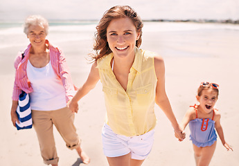 Image showing Portrait, smile and family holding hands on beach for walking in summer on travel, vacation or holiday. Grandma, mother and daughter outdoor together on sand by sea or ocean for love and bonding