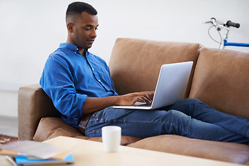 Image showing Man, laptop and typing for remote work at home, freelancer and copywriting in living room. Black male person, online and plan on tech or connection for website, information and research for article