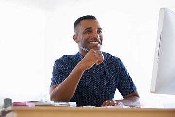 Image showing Business man, computer and desk in office for working or planning at organization or company. African person and intern or trainee with technology and online for job or career in South Africa