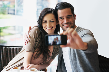 Image showing Couple, smile and date at cafe taking selfie for posting, blog or happy in restaurant with coffee, tea or latte. People, bonding or love together for pictures for social media, online or indoors