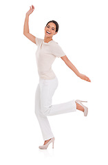 Image showing Woman, excited and celebration in studio for success, winning and achievement with fashion, bonus or sale. Portrait of a winner or happy model in heels with wow, jump or yes on a white background