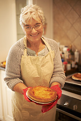 Image showing Elderly lady, pie and smiling in kitchen at home for baking, cooking or retirement leisure. Happy, and proud senior person or grandmother with glasses for food recipes, meals and hobby in house