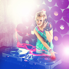 Image showing Woman dj, headphones and listen in night club for party with turntable, neon lights and lens flare. Gen z female person, smile or mixing decks at event with happy, techno and music in Berlin disco