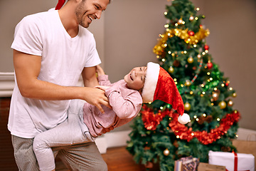 Image showing Father, son and laughing with bonding on christmas for celebration, play and love in the morning with santa hats. Family, man and child with smile, relax and enjoying holiday season in lounge of home