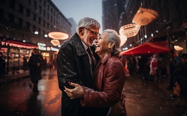 Image showing In the serene snowfall, an elderly couple shares a heartfelt embrace, enveloped in the warm glow of love on a wintry night