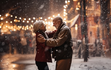 Image showing In the serene snowfall, an elderly couple shares a heartfelt embrace, enveloped in the warm glow of love on a wintry night