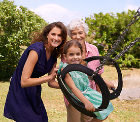 Image showing Swing, portrait and smile with family at park for holiday, playful and playground game together. Happiness, summer and vacation with women and pushing child in nature for relax, bonding and love