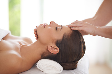 Image showing Spa, massage and hands on head of woman to relax on table for skin care, treatment or facial. Calm, person and girl in salon or resort on holiday or vacation with wellness and healthy stress relief
