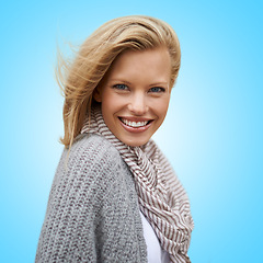 Image showing Autumn, fashion and portrait of happy woman in studio, blue background or mock up space. Casual, style and girl with beauty from makeup, cosmetics or positive attitude in cardigan, jersey and scarf