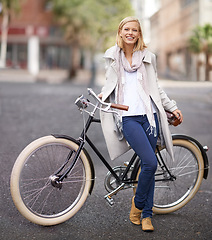 Image showing Happy, portrait and woman with bicycle in city for travel outdoor in Amsterdam on adventure. Vacation, journey or girl cycling on holiday with bike on road, street or smile with sustainable transport