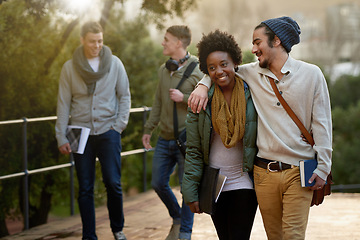 Image showing Interracial, couple and college student with hug in outdoor, campus and happy with love, support and care. University, education and texbook with notes for research to study for exams and assessment