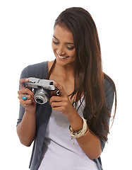 Image showing Woman, photographer and vintage camera in studio, smile and pride for picture or production. Female person, retro equipment and confident for job on white background, photoshoot and happy for hobby
