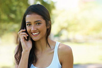 Image showing Portrait, phone call and happy woman in the park for a summer vacation in Canada online. Internet, mobile app conversation and indian female person with a smile on technology while relaxing in garden