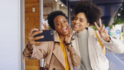 Image showing African, friends and happy selfie in city with phone for photography and memory on social media. Peace, sign and women smile with emoji for post online, blog or virtual communication on smartphone