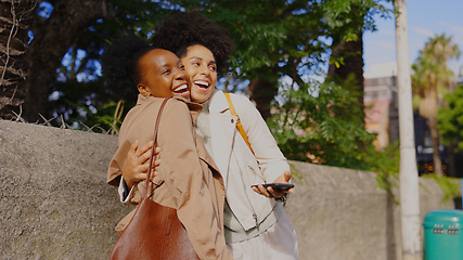 Image showing Happy, hug and women friends in a city excited, greeting and enjoy outdoor reunion or hanging out. Smile, embrace and cheerful people downtown for fun, travel or urban trip, vacation or weekend chill