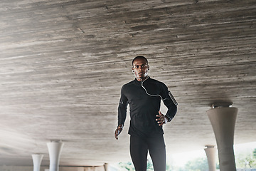 Image showing Man, portrait and runner for fitness outdoor with music, listening to podcast and exercise for healthy body. Athlete, person and earphones with audio, radio or mockup for marathon training in parking