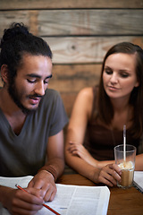 Image showing Students, learning and studying for university at cafe with friends and talking about notes on project. College, education and people planning ideas together at coffee shop in conversation with book