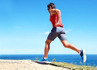 Image showing Man, beach and earphones for workout outdoors, jog and athlete for performance training by sea. Male person, full body and back for run in nature, blue sky and listen to music for exercise on mockup