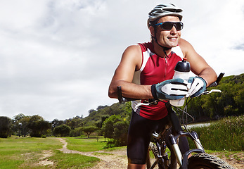Image showing Fitness, smile and man cycling in countryside for training, cardio or adventure on off road path. Exercise, sports and thinking with cyclist person on bike in nature for health, workout or challenge