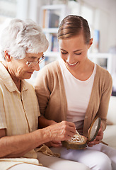 Image showing Mother, elderly woman and daughter with pearl necklace, home and conversation in a living room. Family, old lady and adult on a couch, relaxing and discussion with jewelry, present or inheritance