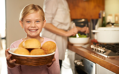 Image showing Portrait, young girl and cooking with mother, kitchen and bread basket for family dinner. Smile, proud and development of food education, preparation and nutrition or bonding with mom at home