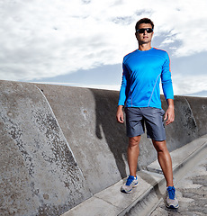 Image showing Man, promenade and ready for run outdoors, fitness and athlete for performance training. Male person, full body and sunglasses for workout on weekend, outside and prepare for exercise challenge