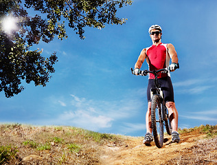 Image showing Nature, cycling and man cyclist with bicycle in park for marathon, race or competition training. Fitness, sports and portrait of athlete riding bike for cardio workout or exercise in outdoor forest.