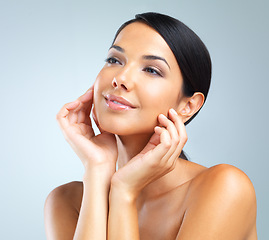 Image showing Woman, touching face and natural beauty with cosmetics, dermatology and wellness on grey background. Skincare for healthy glow, facial and self care with smooth skin, shine and happy model in studio