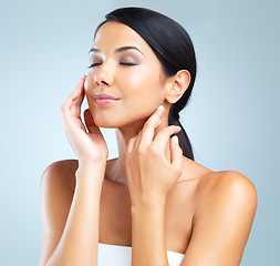 Image showing Skincare, glow and woman with cosmetics, beauty and wellness on grey studio background. Person, model and girl with grooming and shine with treatment and facial with makeup, aesthetic and dermatology