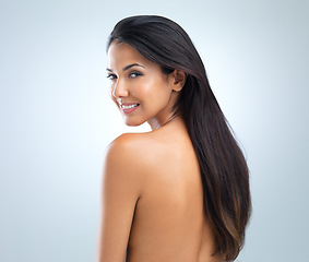 Image showing Woman, beauty and hair with cosmetics, model in studio with shine and keratin treatment on grey background. Haircare, cosmetology and skin for wellness, texture and growth in portrait with smile